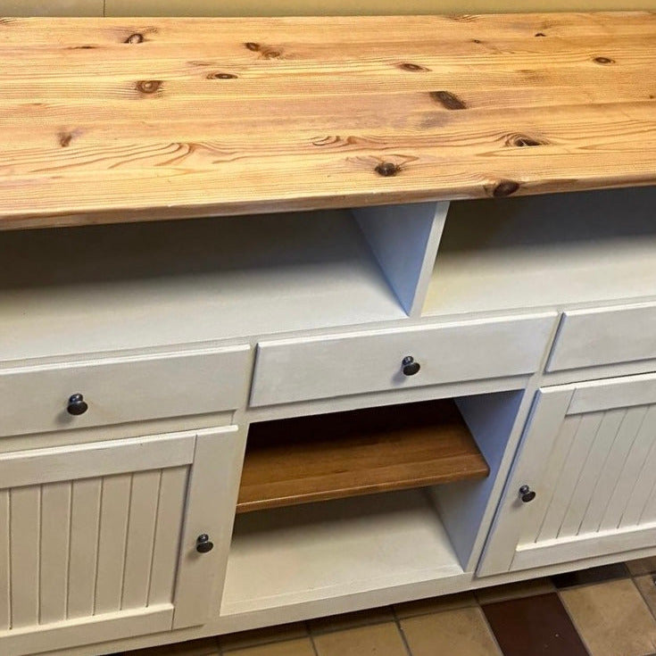 En sliten köpmansdisk målades och fick tapeter i Morrisdesign i lådorna och baktill så att den går att använda som köksö eller bar.